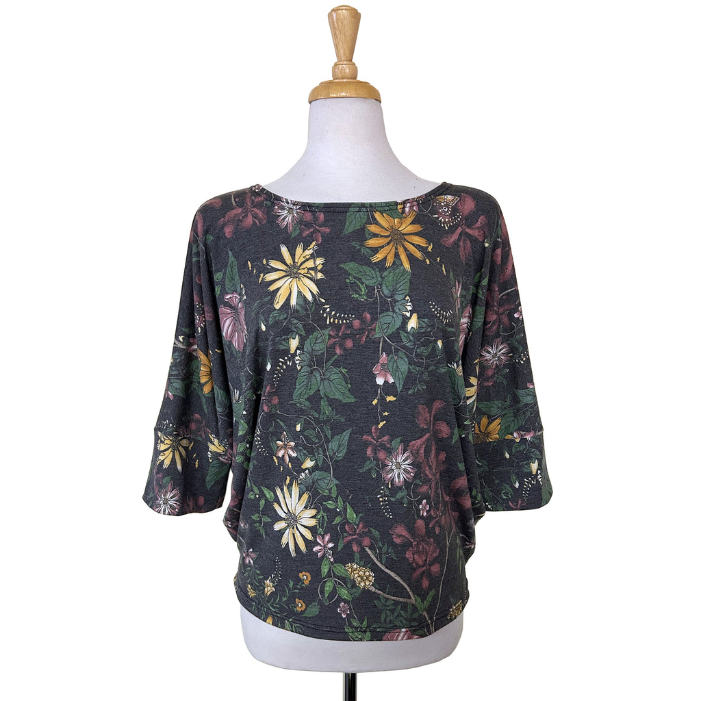 Batwing Top with 3/4 sleeves in a lovely muted floral print in pink, yellow and green on a classic charcoal background. An elegant print on a flattering cut and a cozy feel.