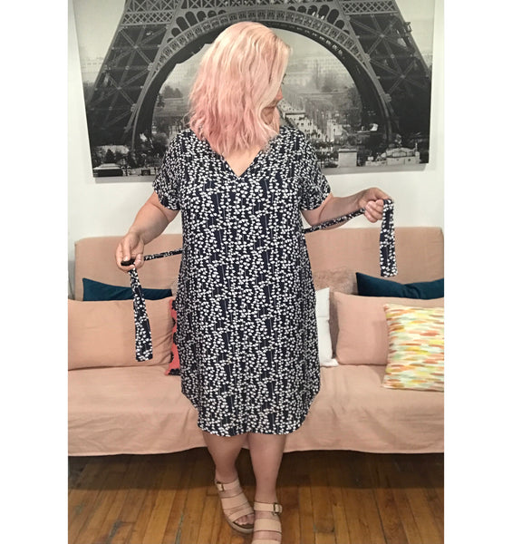 Face printed dress with pockets. Diversity print. multi cultural print. Short sleeve. v-neck. fun and unique dress. loose fitting dress. tunic dress. fun printed tunic dress. Belted dress. Long belted shirt dress.  Edit alt text