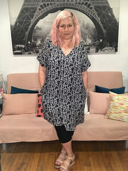 Face printed dress with pockets. Diversity print. multi cultural print. Short sleeve. v-neck. fun and unique dress. loose fitting dress. tunic dress. fun printed tunic dress. Belted dress. Long belted shirt dress.  Edit alt text