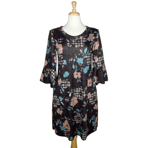 Fun knee length dress with plaid and florals. blue flowers, pink flowers, and charcoal and beige plaid flowers, all on a charcoal background. 3/4 length sleeve with flounce cuff. crew neck style with pockets. fabric is stretchy knit with 2% spandex. other fabrics are rayon and poly.