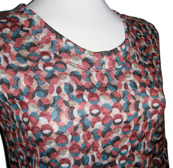 Fun knee length dress with pink, teal, and charcoal polka dots that over lay each other. Mod style print. 3/4 length sleeve with flounce cuff. crew neck style with pockets. fabric is stretchy knit with 2% spandex. other fabrics are rayon and poly.