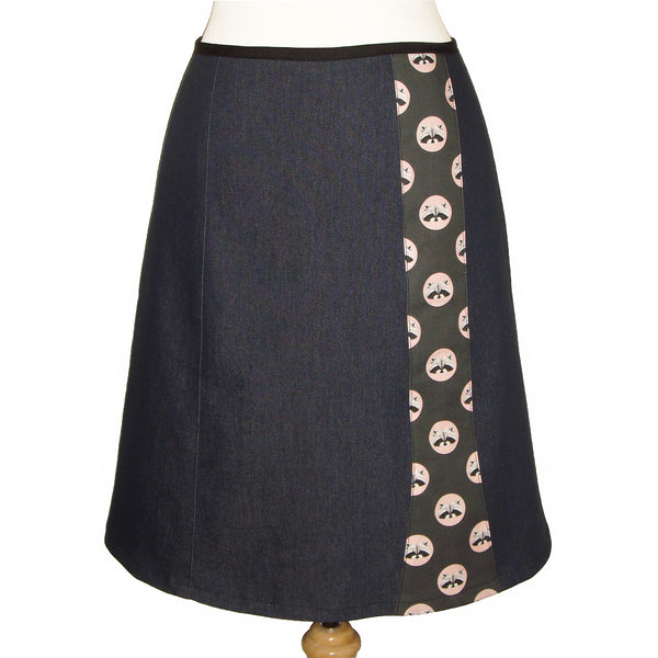 dark denim knee length skirt with polka dots and raccoon face print.